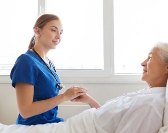 caregiver holding senior womans hands