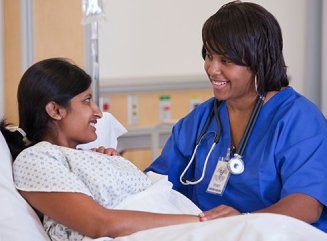 caregiver holding senior womans hands